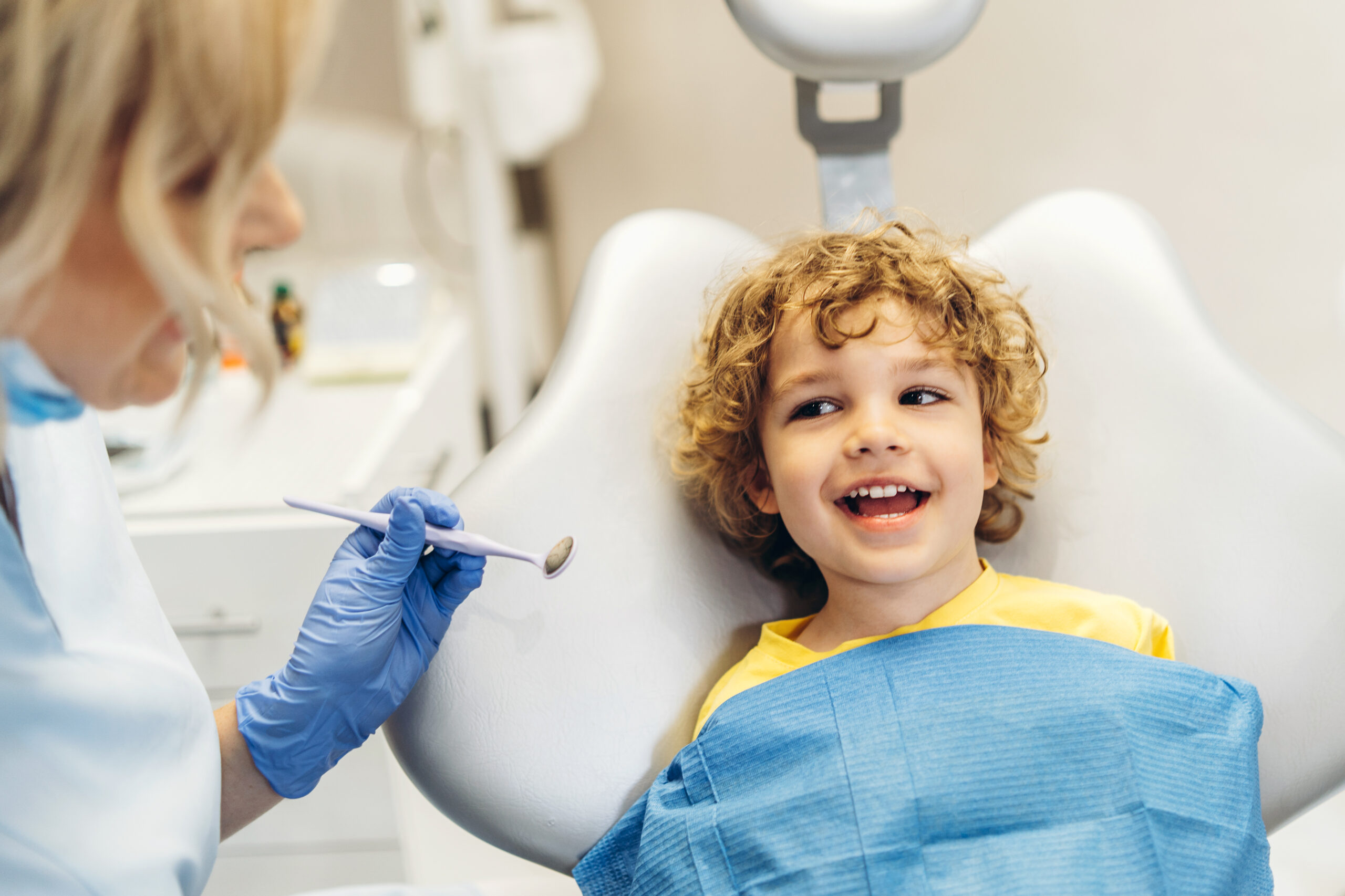 Cute Young Boy Visiting Dentist Having His Teeth Checked By Female Dentist Dental Office Scaled